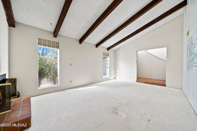 carpeted living room with lofted ceiling with beams and a textured ceiling