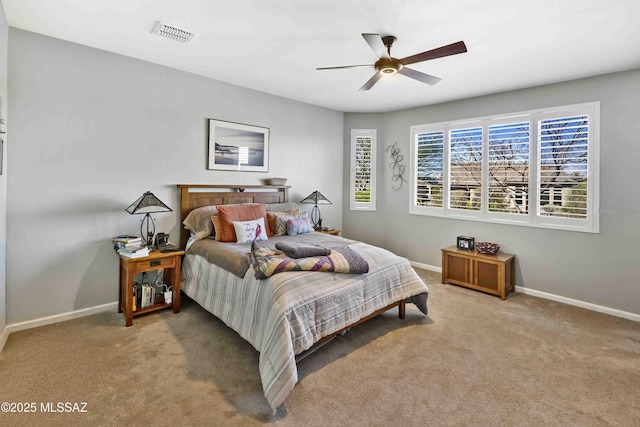 bedroom with ceiling fan and light carpet