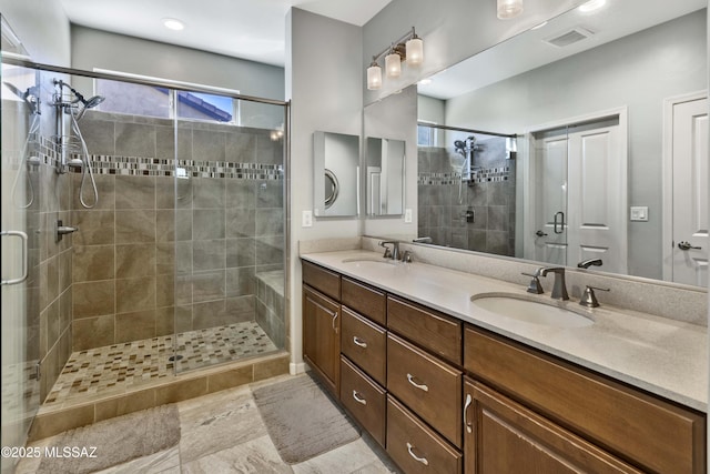 bathroom featuring vanity and an enclosed shower