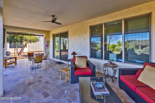 view of patio featuring an outdoor living space with a fire pit and ceiling fan