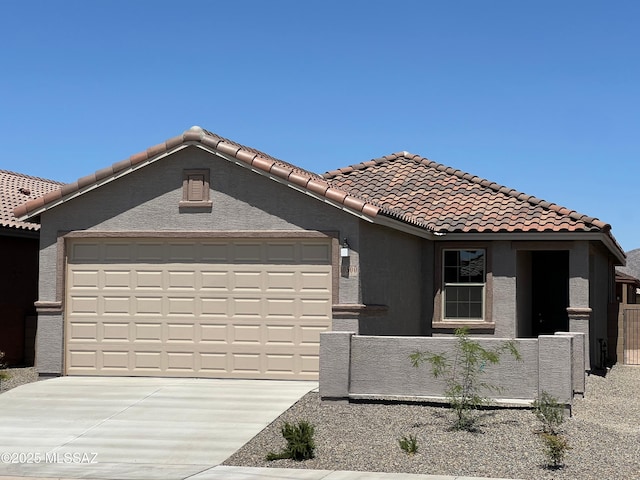 single story home featuring stucco siding, fence private yard, a garage, a tile roof, and driveway