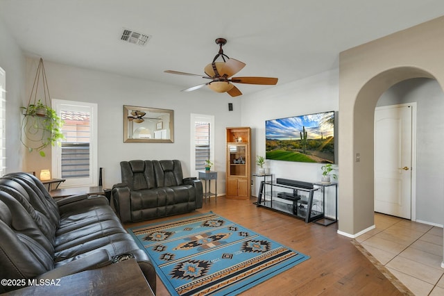 living room featuring hardwood / wood-style flooring and ceiling fan