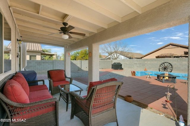 view of patio / terrace with grilling area, an outdoor living space with a fire pit, and ceiling fan