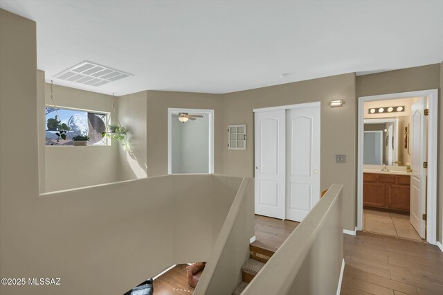 hall with sink and light hardwood / wood-style floors