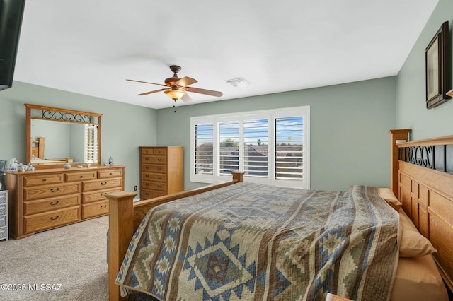 bedroom with ceiling fan and light colored carpet