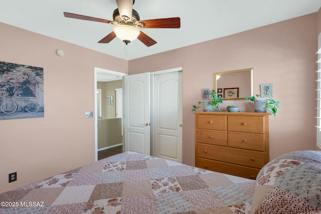 bedroom with ceiling fan and a closet