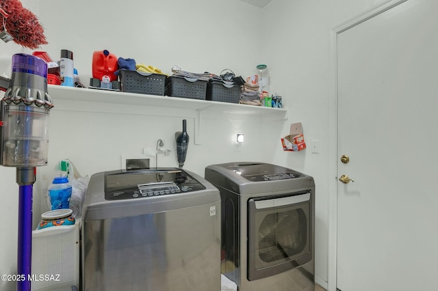 clothes washing area featuring independent washer and dryer