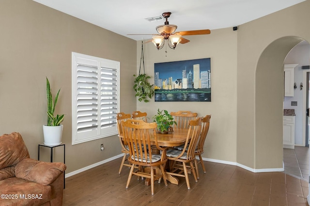 dining room featuring ceiling fan and dark hardwood / wood-style floors