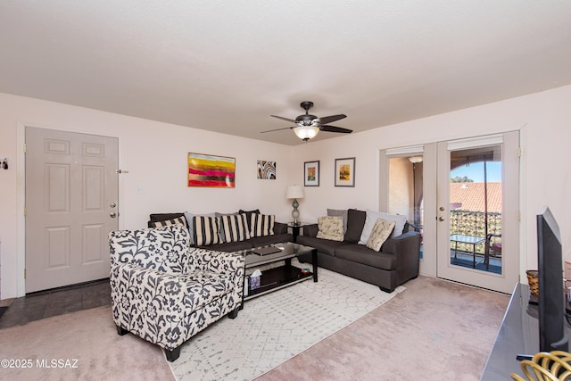 carpeted living room featuring french doors and ceiling fan