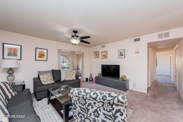 living room with light colored carpet and ceiling fan