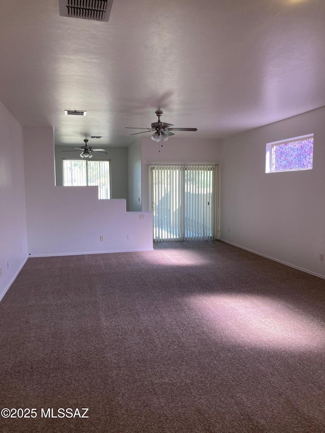 empty room with ceiling fan and carpet