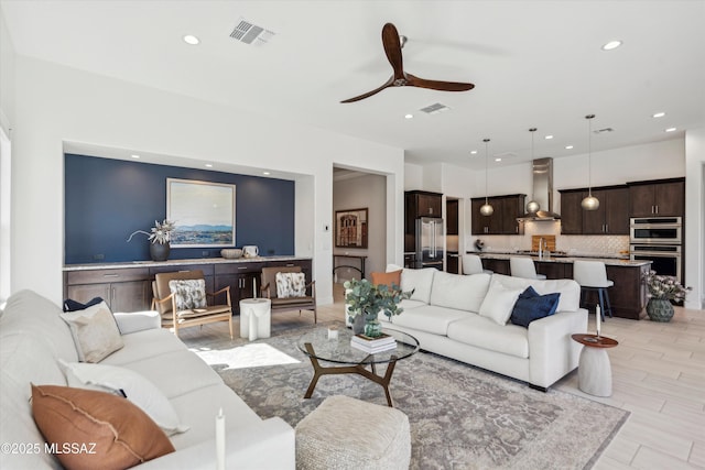 living room featuring ceiling fan and light wood-type flooring