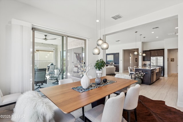 dining room featuring sink and ceiling fan