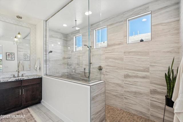 bathroom featuring vanity and a tile shower