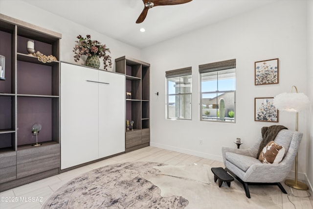 sitting room featuring ceiling fan