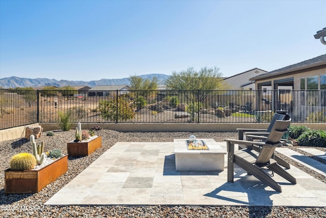 view of patio / terrace with an outdoor fire pit and a mountain view