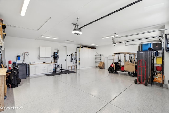 garage featuring a garage door opener and a workshop area