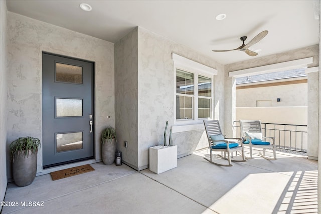 property entrance featuring covered porch and ceiling fan