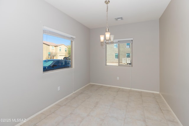 unfurnished room with a chandelier