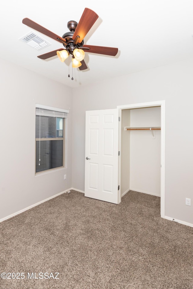 unfurnished bedroom featuring ceiling fan, a closet, and carpet