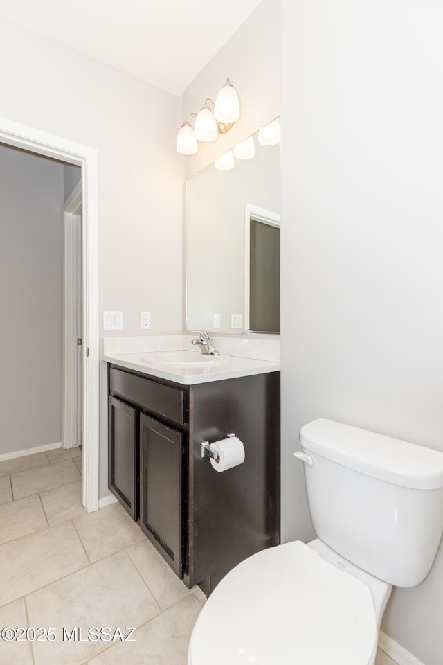 bathroom featuring tile patterned flooring, vanity, and toilet