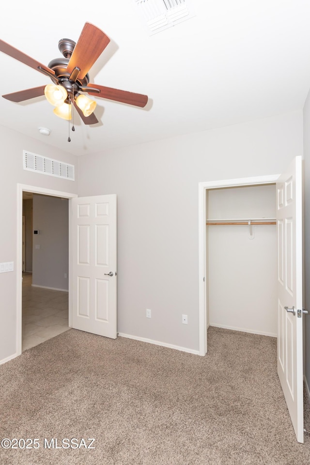 unfurnished bedroom with a closet, ceiling fan, and carpet