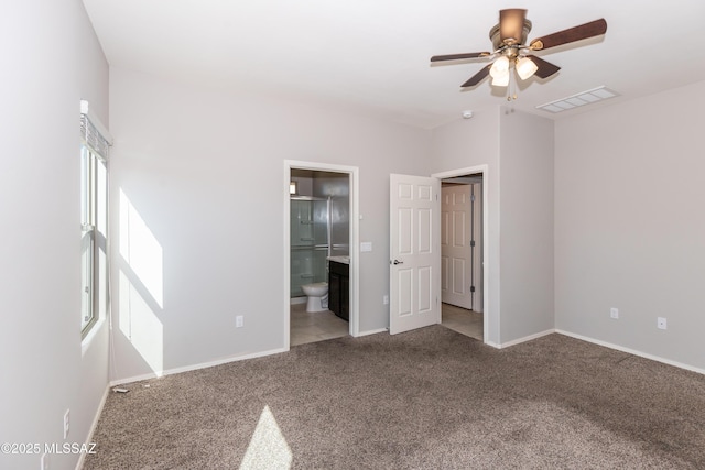 unfurnished bedroom featuring ensuite bath, ceiling fan, and carpet