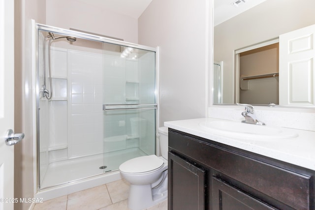 bathroom featuring walk in shower, tile patterned floors, toilet, and vanity