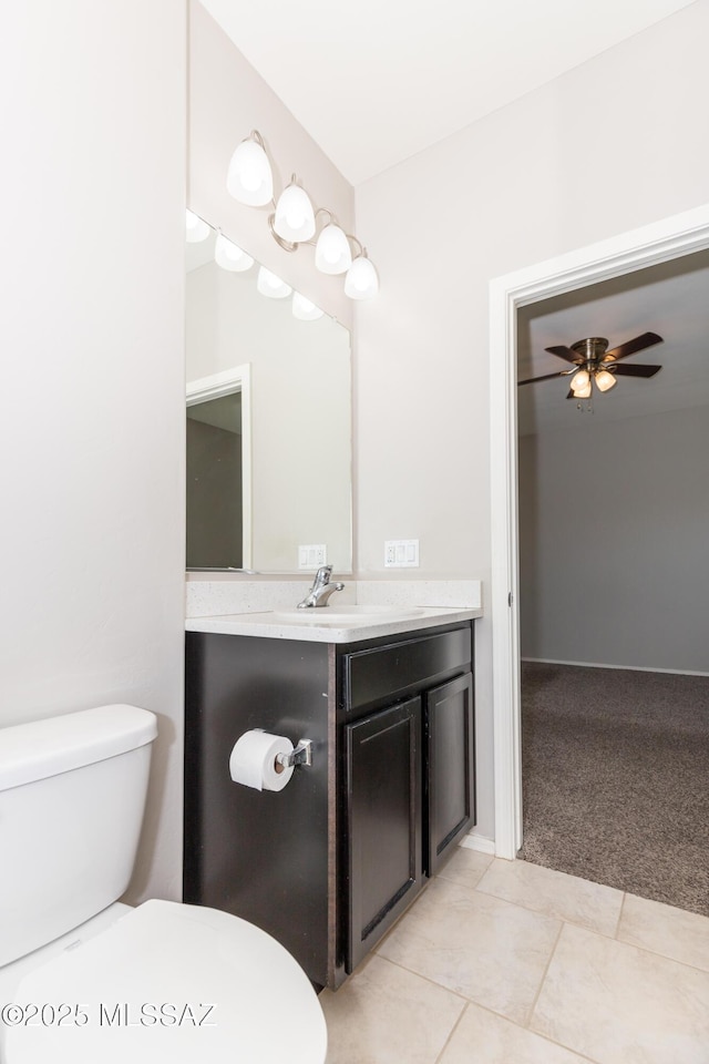 bathroom featuring ceiling fan, vanity, toilet, and tile patterned floors