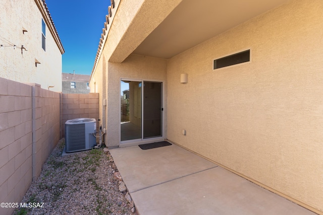 entrance to property featuring cooling unit and a patio area