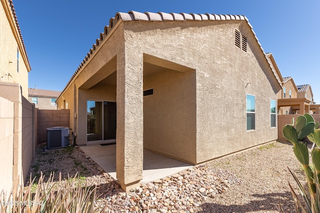 back of property featuring central AC unit and a patio area