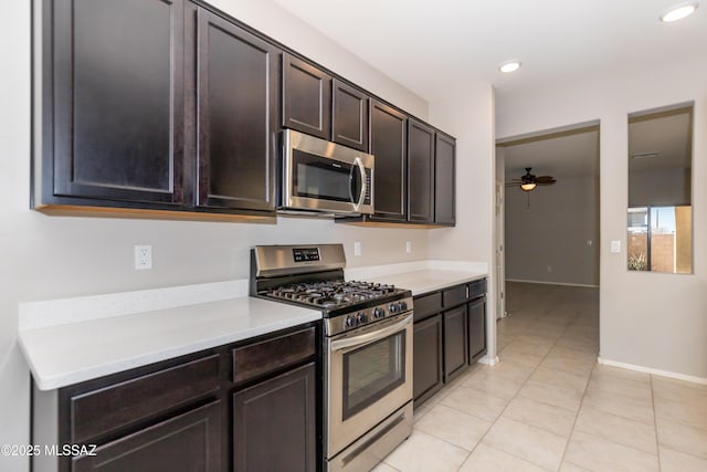 kitchen with ceiling fan, stainless steel appliances, dark brown cabinetry, and light tile patterned floors