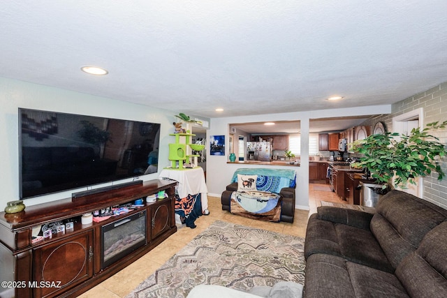 living area featuring baseboards, light tile patterned flooring, and recessed lighting