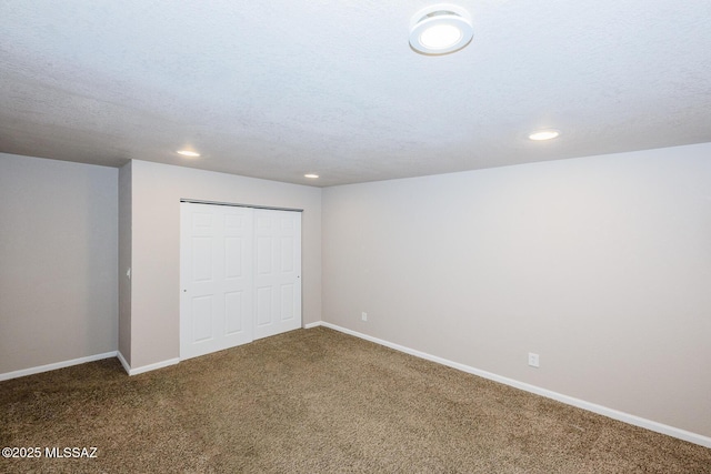 unfurnished bedroom featuring carpet floors, a closet, and baseboards