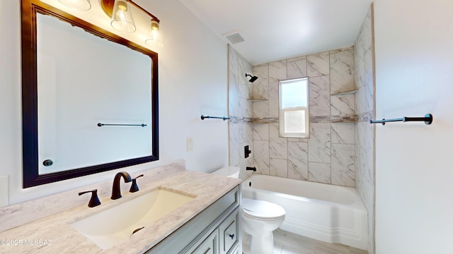 full bathroom with vanity, toilet, and tiled shower / bath