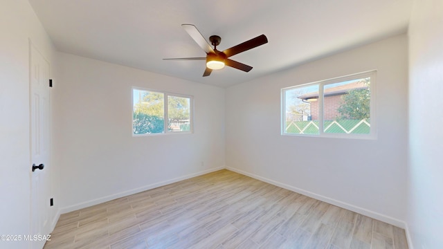 empty room featuring ceiling fan and light hardwood / wood-style flooring