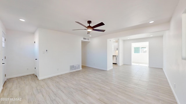 unfurnished room featuring ceiling fan and light hardwood / wood-style floors