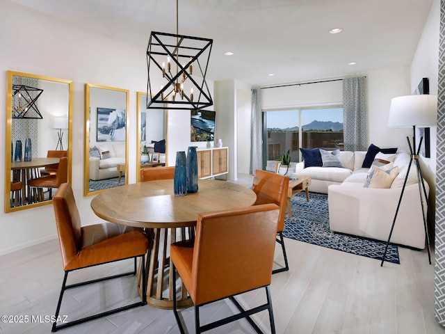 dining area featuring an inviting chandelier and light hardwood / wood-style floors