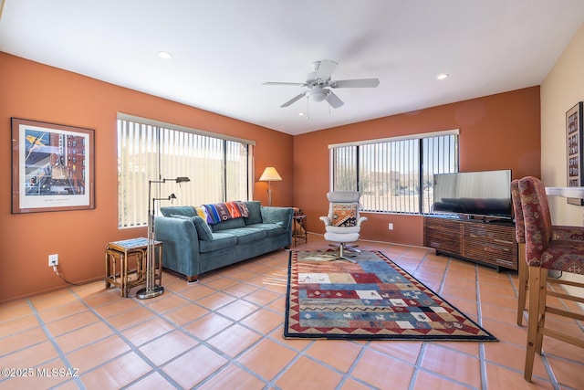 tiled living area featuring a ceiling fan, recessed lighting, and a healthy amount of sunlight