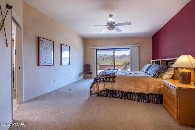 bedroom featuring access to outside, a ceiling fan, and light colored carpet