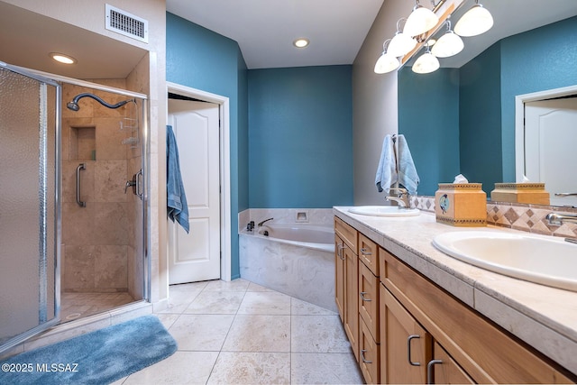 bathroom featuring tile patterned flooring, a sink, visible vents, and a shower stall