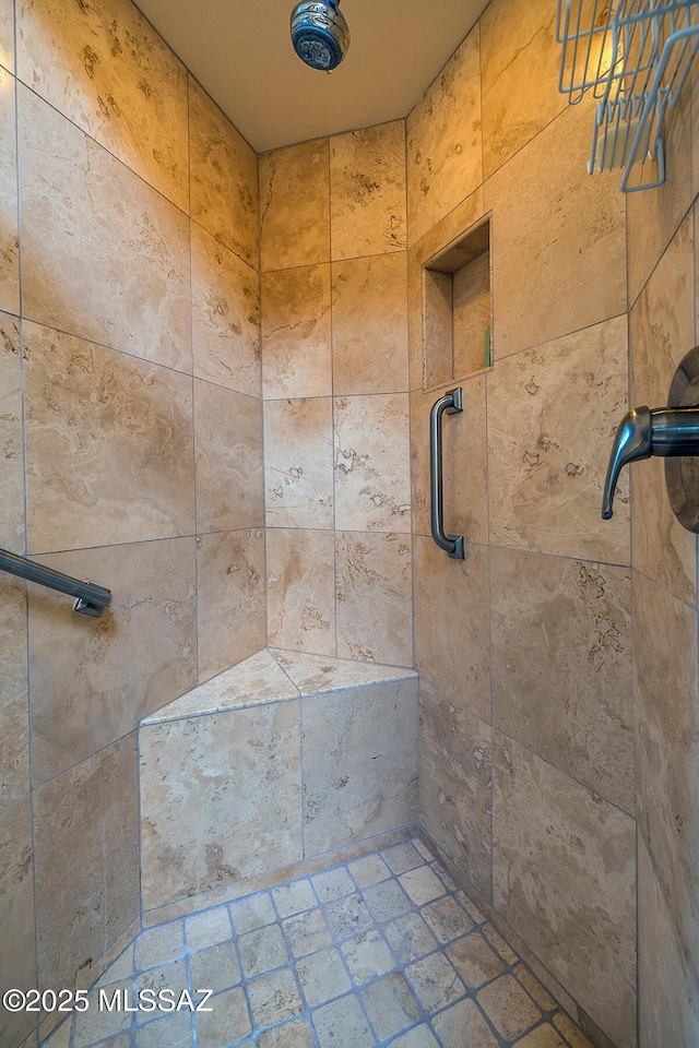 bathroom with a tile shower