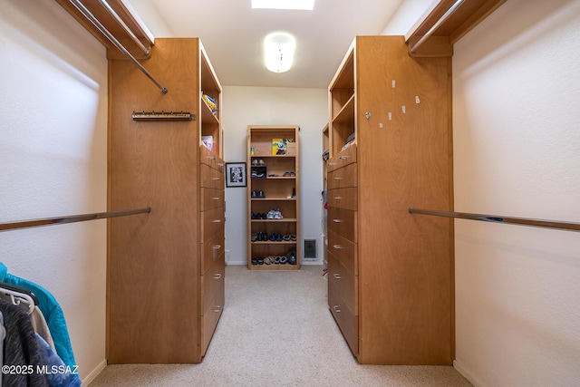 spacious closet with light colored carpet and visible vents