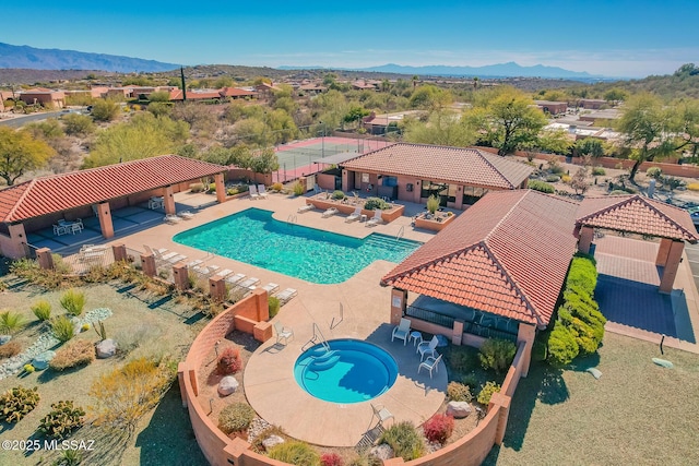 pool with a patio area, a mountain view, and a gazebo