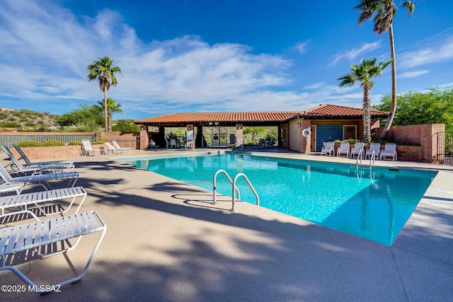 pool featuring a patio area and fence