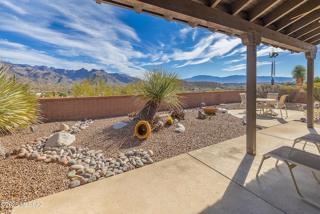 view of patio / terrace featuring a fenced backyard and a mountain view