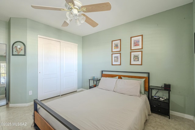 tiled bedroom with ceiling fan and a closet