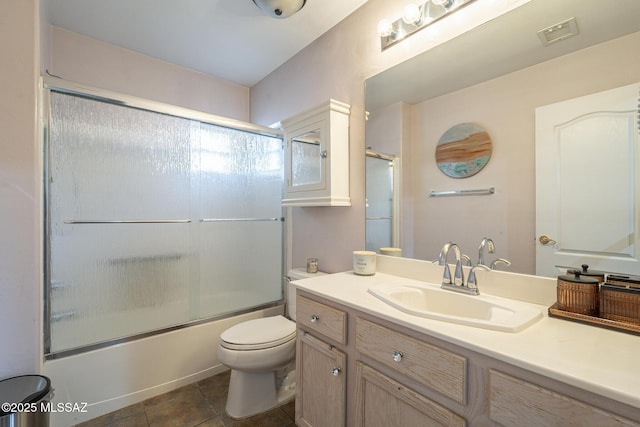 full bathroom with vanity, tile patterned floors, shower / bath combination with glass door, and toilet