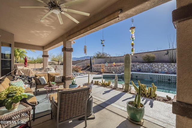 view of patio with a fenced in pool, outdoor lounge area, and ceiling fan