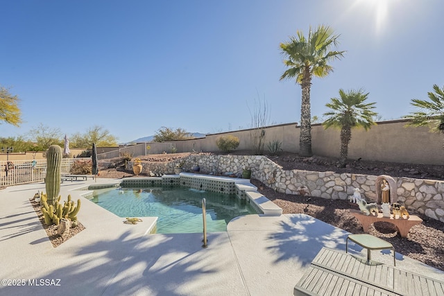 view of swimming pool featuring pool water feature and a patio area